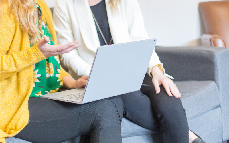 Two women looking at a laptop