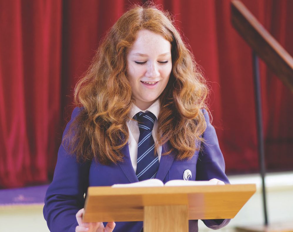 A girl standing at the lectern