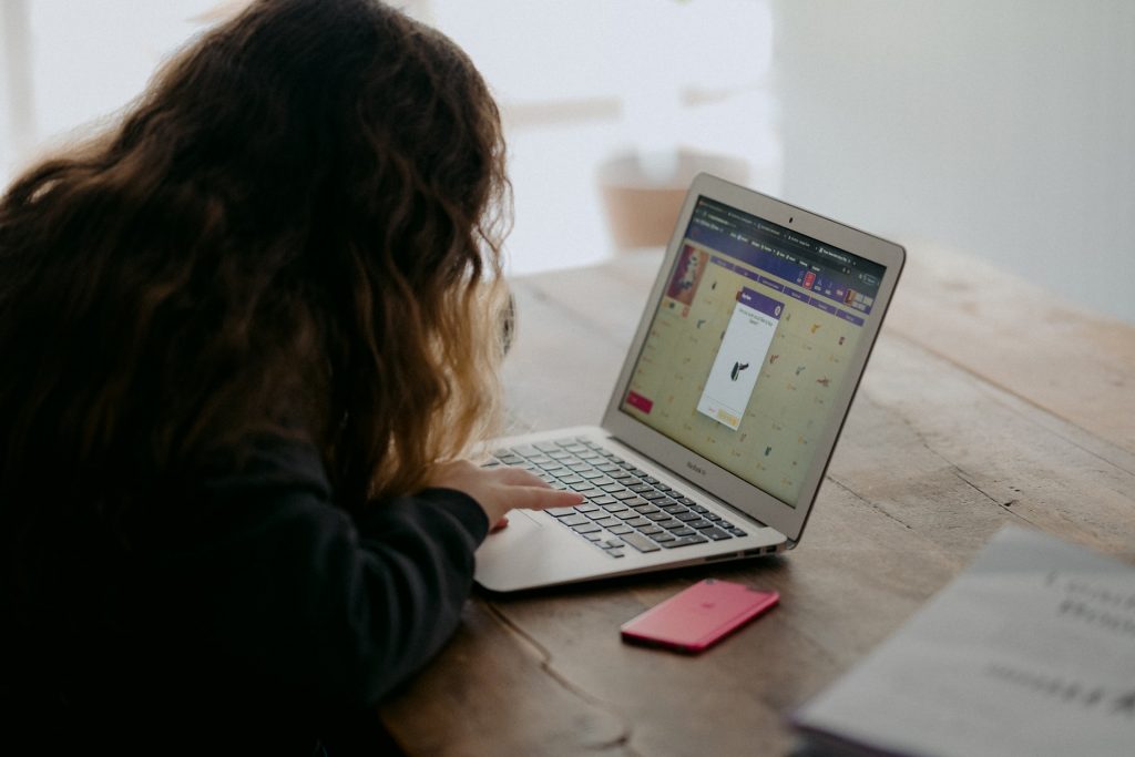 A girl using a laptop at a table