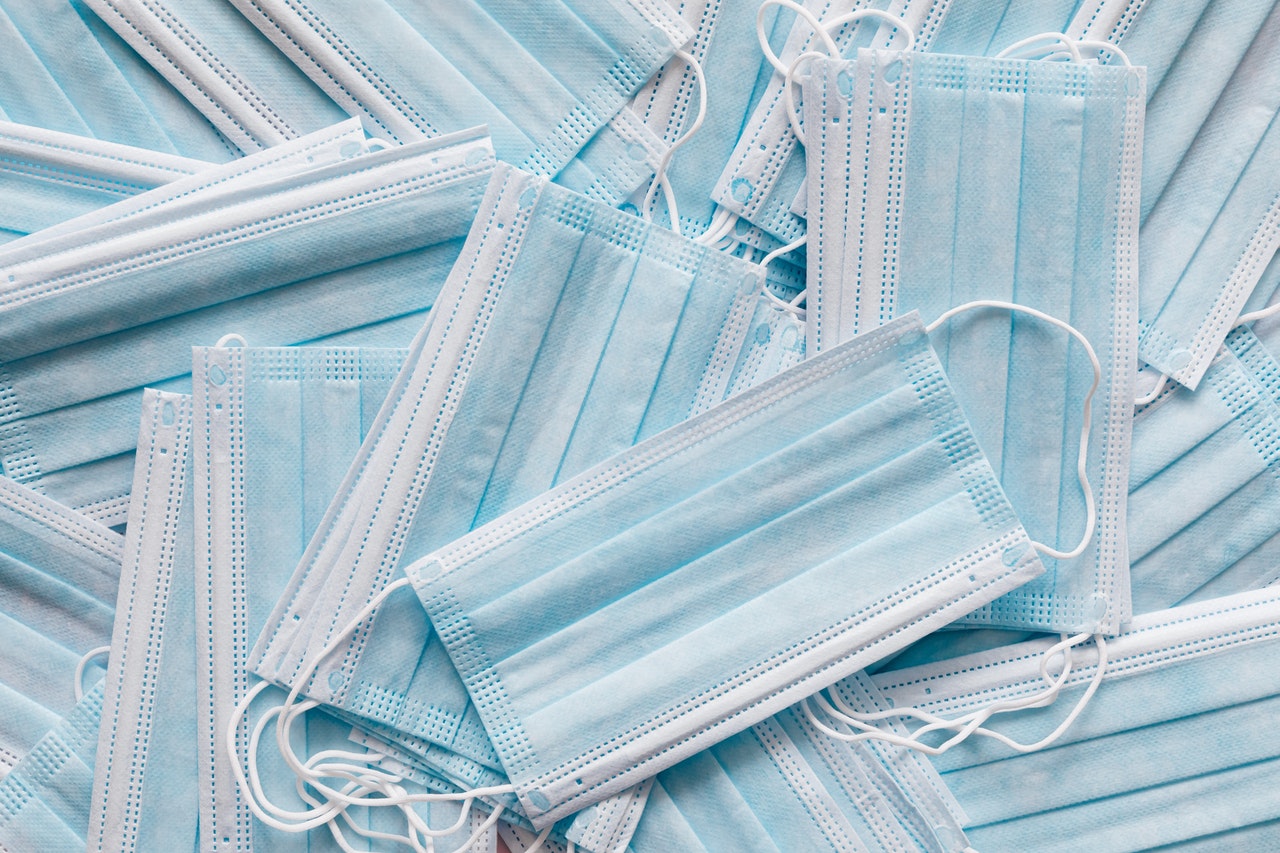 A pile of blue disposable face masks